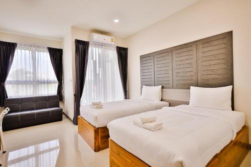 Voodi või voodid majutusasutuse Pak Ping Ratchabur toas
