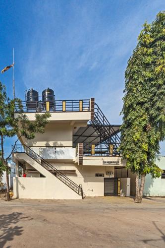 a building with a staircase on the side of it at Krishna Homestay Hampi in Hampi