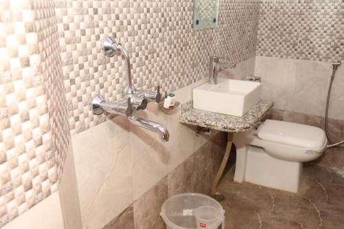 a bathroom with a sink and a toilet at Hotel Rang Sagar Haveli in Udaipur