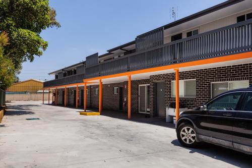 a car parked in front of a building with orange poles at Singleton Valley Accommodation in Singleton