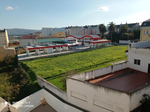 een groen dak boven een gebouw met een speeltuin bij Apartamentos Maranata Foz in Foz