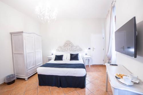 a bedroom with a bed and a table with a tv at Residenza Florentia in Florence
