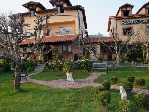 a large building with a garden in front of it at Posada rural el rincón de Cabrojo in Cabrojo