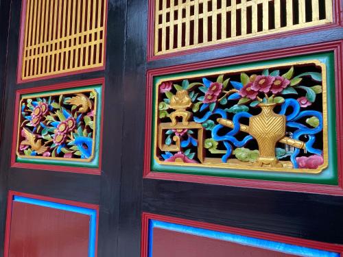 a colorful door with a window with a vase on it at The Chen Story II in Jincheng