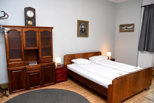 a bedroom with a bed and a cabinet and a clock at Santa Sofia in Sofia
