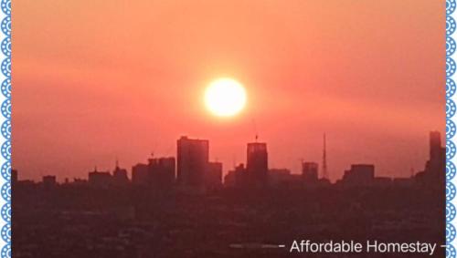 a city skyline with the sun in the sky at 723 Moonlight Place 321-FREE WIFI in Antipolo