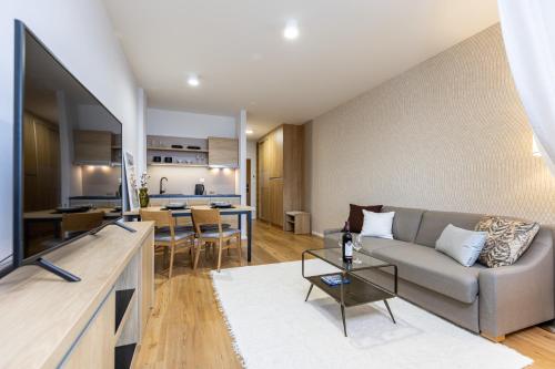 a living room with a couch and a table at Apartman Lucid C207 in Smokovce