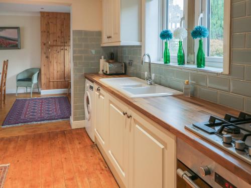 a kitchen with a sink and a counter top at Lower Cross in Keighley