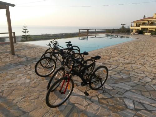 a group of bikes parked next to a pool at Natura Club Hotel & Spa - Adults Guests in Kyparissia
