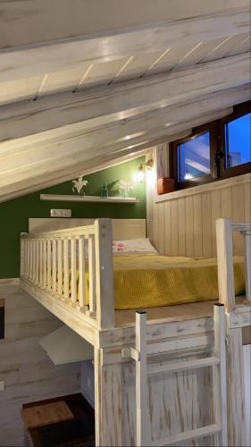 a small bedroom with a bunk bed in a house at Apartamentos A Poniente in Villanueva de la Concepción