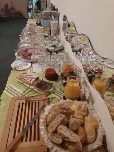 a long table filled with bread and glasses of orange juice at Pension Pretty in Harrachov