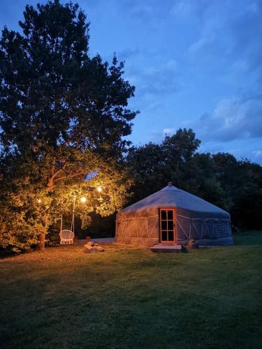 a yurt in a field at night with lights at VasaRojaus Jurta in Birštonas