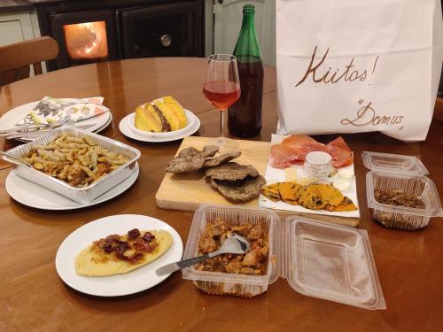 a table with plates of food and a glass of wine at Casa Martin , 4 bedroom villa in Bisenti