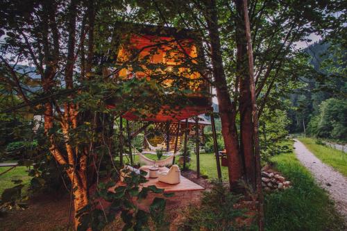 a tree house in the middle of some trees at House Raduha in Luče