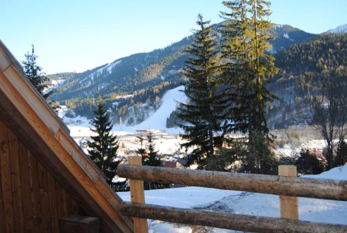 a view of a snow covered mountain from a cabin at La Lince Lodge in Camporosso in Valcanale