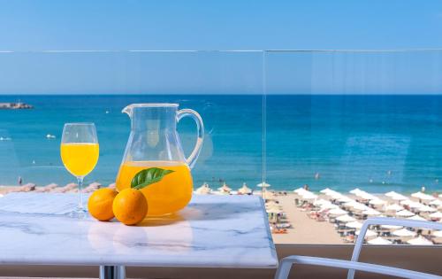 a glass of orange juice sitting on top of a table at Ilios Beach Hotel Apartments ADULTS ONLY in Rethymno