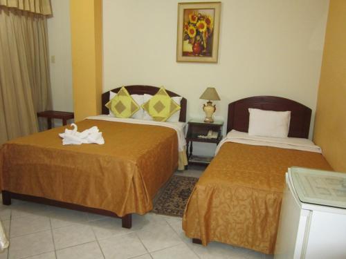 a hotel room with two beds in a room at Hotel Plaza Bolognesi 344 in Trujillo