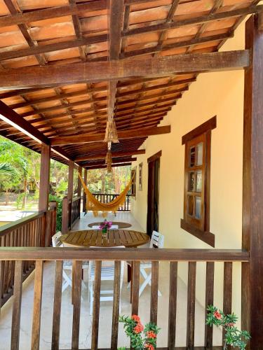 a porch with a wooden roof with a swing at Loft Jeri in Jericoacoara