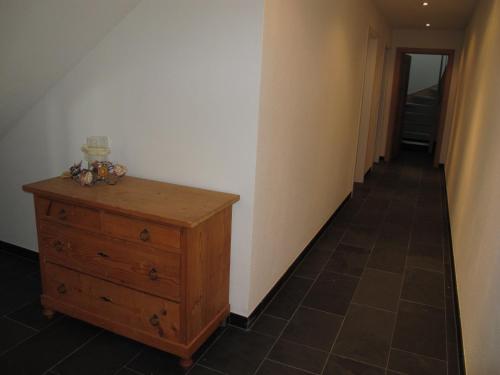 a hallway with a wooden dresser and a hallway with a hallway at Haus Kibitz in Fieberbrunn
