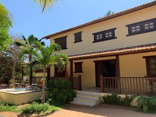 a villa with a swimming pool and a house at Loft Jeri in Jericoacoara