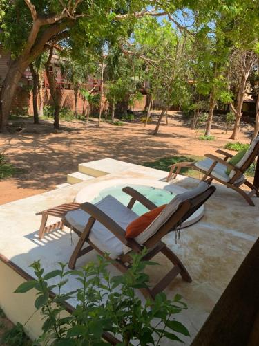 two lounge chairs sitting next to a swimming pool at Loft Jeri in Jericoacoara