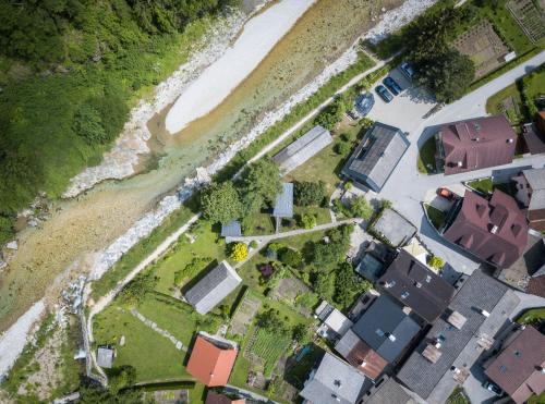 an aerial view of houses and a river at House Raduha in Luče