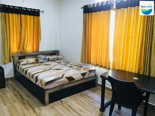Un dormitorio con una cama y una mesa y cortinas amarillas. en River Arena Holidays, en Vagamon