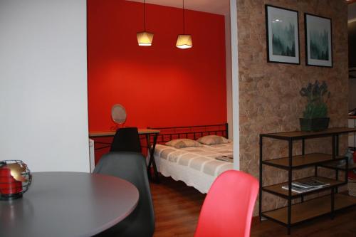 a room with a bed and a table and chairs at Niko Apartments 1 in Krakow