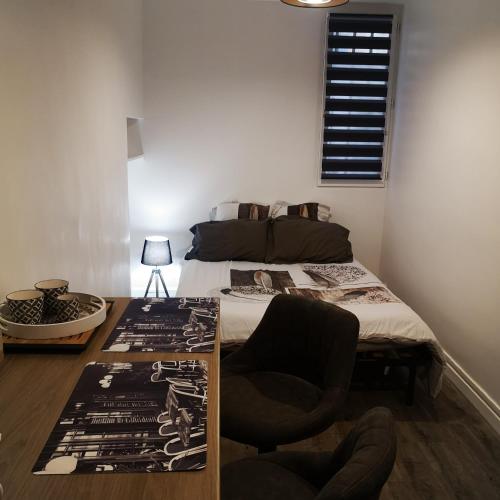 a bedroom with a bed and a table with a chair at studio centre d Aix in Aix-en-Provence