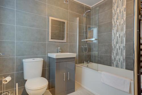 a bathroom with a toilet and a sink and a tub at Sunderland Self-Catering 1 -Chester Cottage in Sunderland