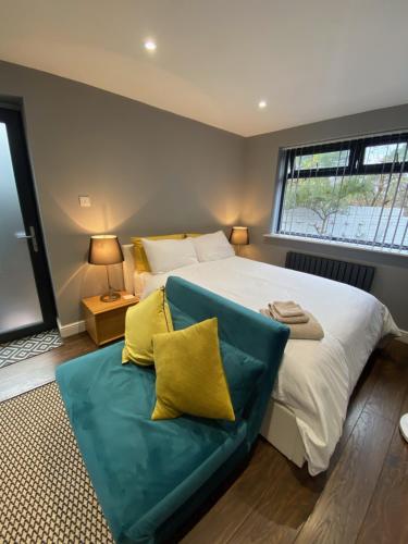 a bedroom with a large bed and a couch at The Annexe in Bracknell