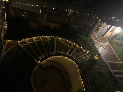 a spiral staircase with lights on a house at night at Villa Anna! in Castrocielo