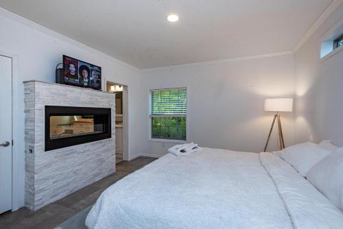 a bedroom with a large bed and a fireplace at Swan Lake Resort in Galloway