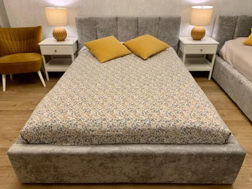 a bed in a room with two tables and a couch at Apartamenty Dobranocka in Krotoszyn