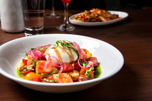 a white bowl of food on a table at Kimpton Schofield Hotel by IHG in Cleveland