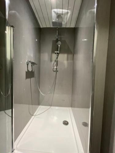 a bathroom with a shower with a glass door at HLA KIrklee in Bellshill