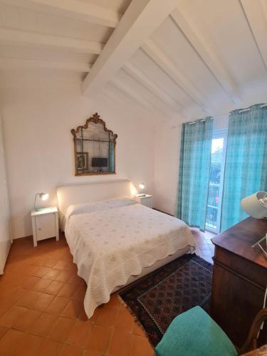 a bedroom with a bed and a mirror on the wall at B&B Luna Nuova in Sarzana