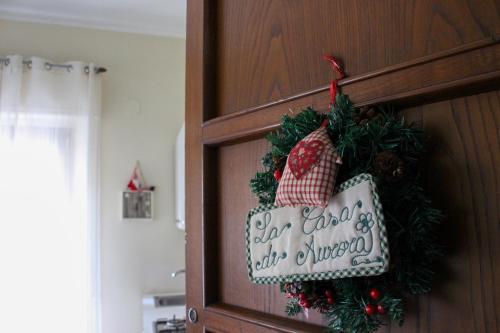 a door with a christmas sign on it at La Casa di Aurora in Reggio Calabria