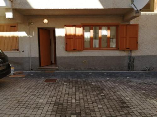 a building with wooden doors and a tiled floor at BEST HOUSE CAMPO DI GIOVE in Campo di Giove