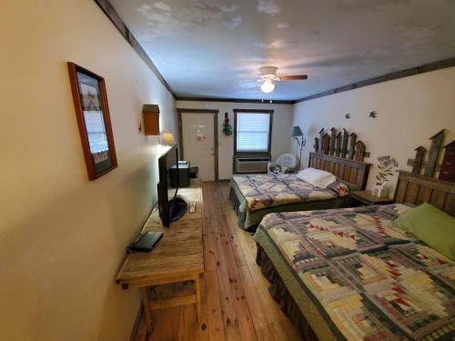 a room with two beds and a table in it at Jamesport Inn in Jamesport