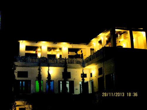 a large white building with lights on it at night at Atithi Guest House Pushkar in Pushkar