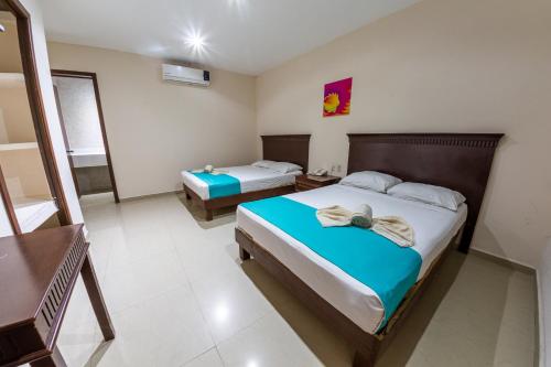 1 Schlafzimmer mit 2 Betten in einem Zimmer in der Unterkunft Hotel Villamar in Veracruz