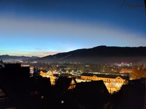 a view of a city at night at Willa Michałówka in Zakopane
