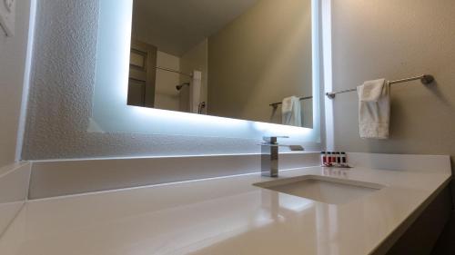 a bathroom with a sink and a mirror at Super 8 by Wyndham Santa Cruz/Beach Boardwalk East in Santa Cruz