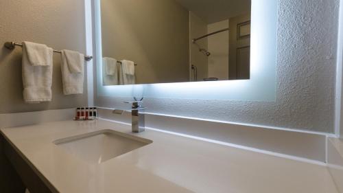 a bathroom with a sink and a mirror at Super 8 by Wyndham Santa Cruz Beach Boardwalk in Santa Cruz