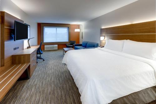 a hotel room with a large bed and a television at Holiday Inn Express & Suites - Middletown - Goshen by IHG in Middletown
