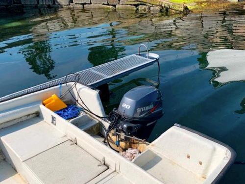 a boat with a grill on the water at 6 person holiday home in Austrheim in Utkeila