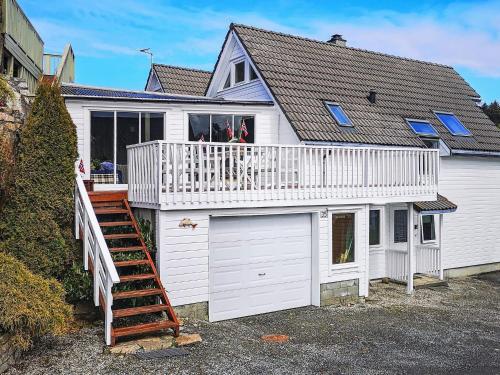a large white house with a white garage at Seaside Fisherman s Haven-By Traum in Steinsbø