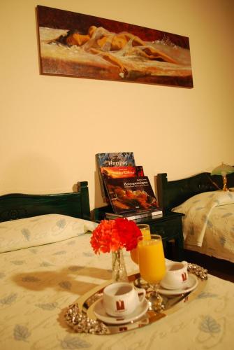 a table with a tray with a candle and flowers on a bed at Hotel Faraggi in Kleidonia