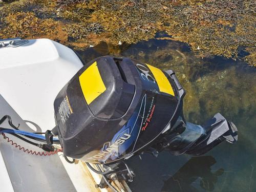a motor on the side of a boat in the water at 6 person holiday home in Farstad-By Traum in Farstad